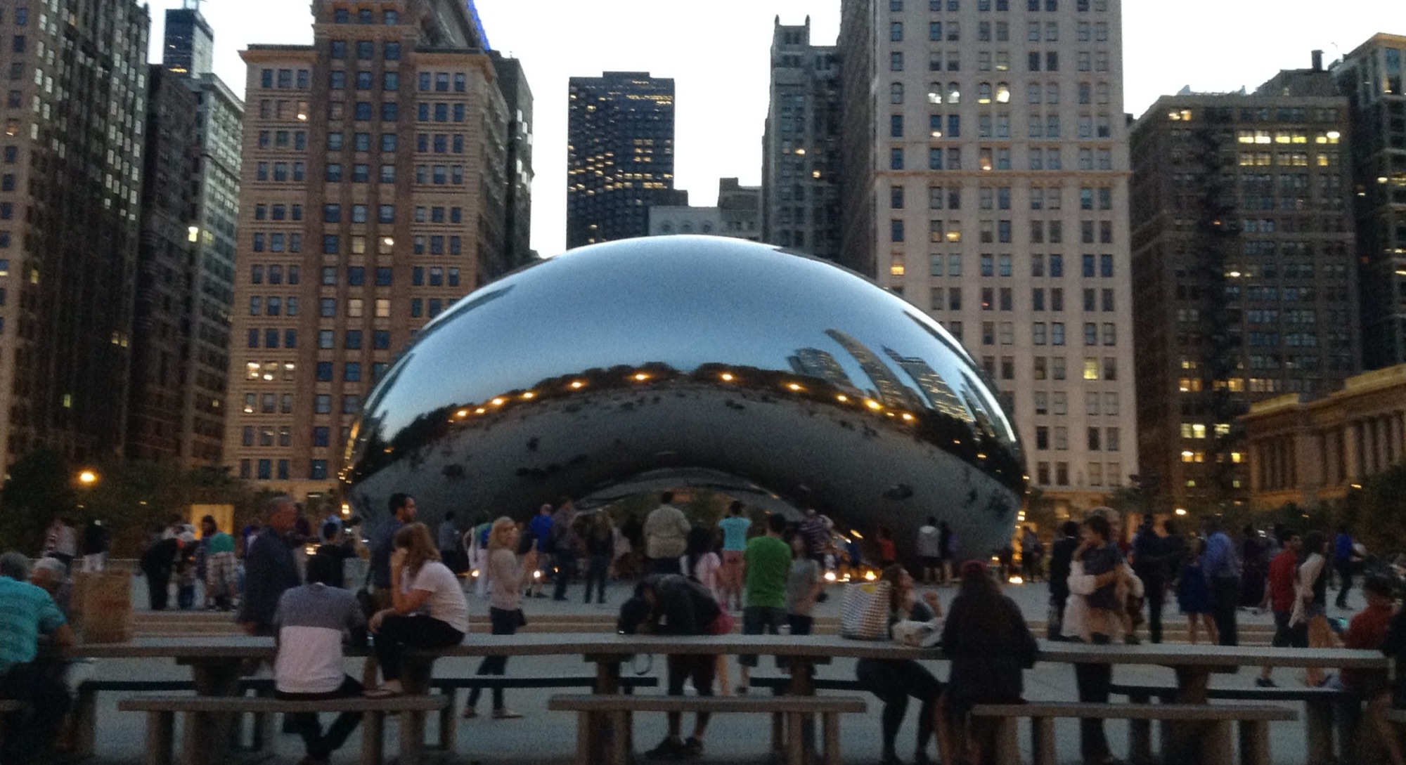 Crowds around the Cloud Gate sculpture (“the Bean”) in Chicago’s Millennium Park at dusk